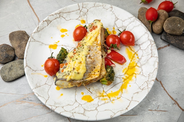 baked sea bream fish with tomatoes peppers sauce and broccoli