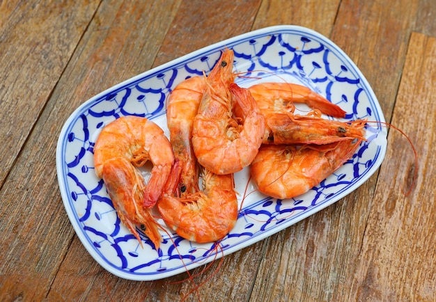 Baked Shrimp on plate again wood table