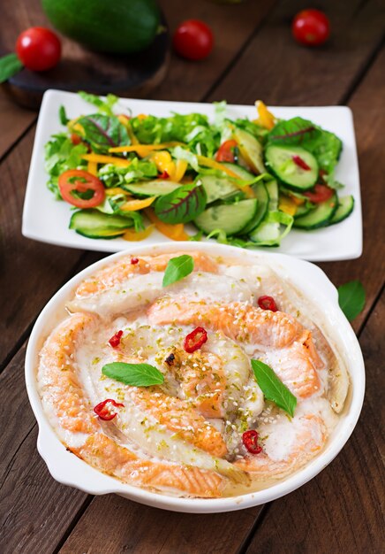 Baked slices of red and white fish with honey and lime juice, served with fresh salad and soft noodles in miso broth