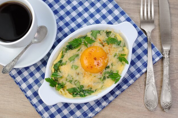 Baked spinach and cheese with egg yolk cup of coffee