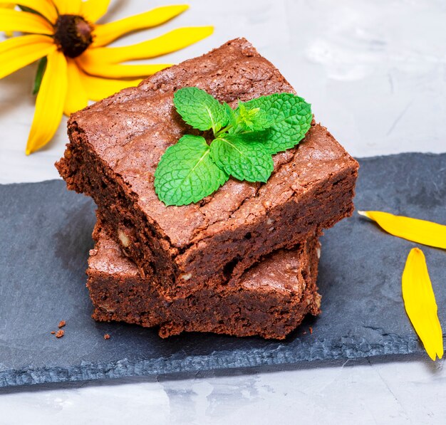 Baked square pieces of chocolate pie with walnuts 