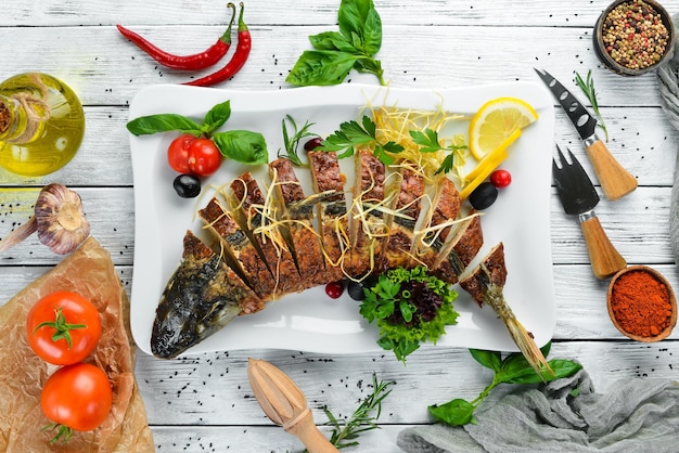 Baked stuffed fish carp with vegetables Restaurant dishes Top view Free space for your text
