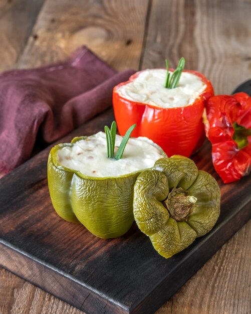 Baked stuffed peppers with ricotta on the wooden board