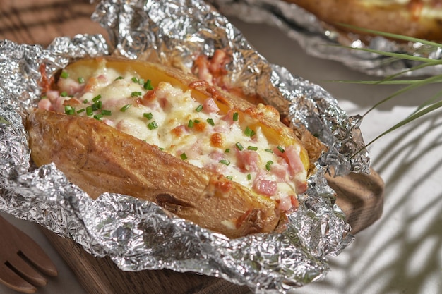 Baked stuffed potatoes with cheese ham and chives