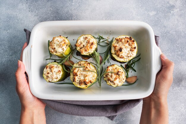 Baked stuffed zucchini with minced chicken and vegetables