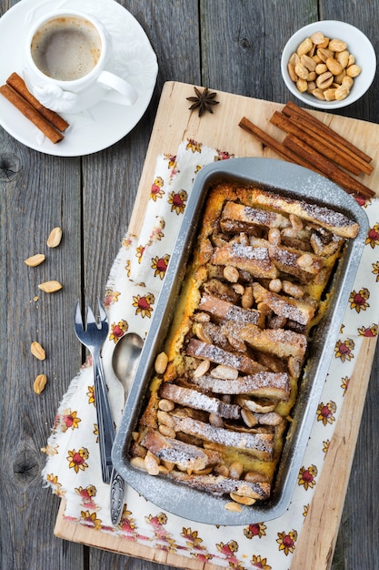 Baked toast with bananas and peanuts on the old wooden