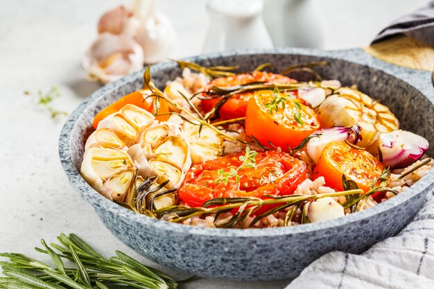 Baked tomatoes with brown rice in pan