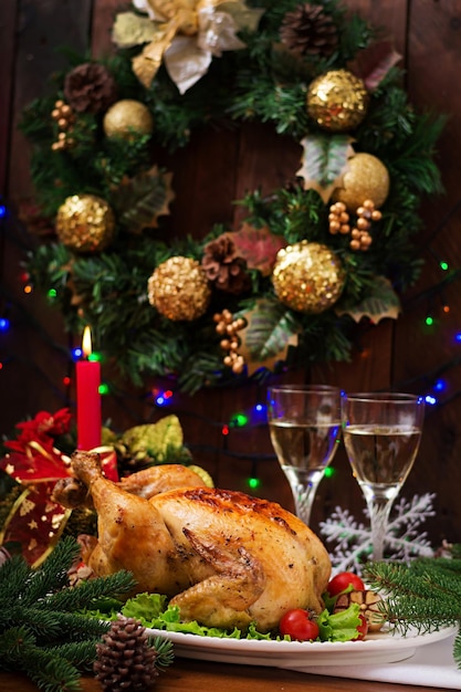 Baked turkey or chicken The Christmas table is served with a turkey decorated with bright tinsel and candles Fried chicken table Christmas dinner
