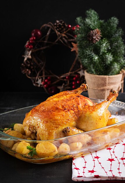 Baked turkey or chicken The Christmas table is served with a turkey decorated with bright tinsel Fried chicken table Christmas dinner