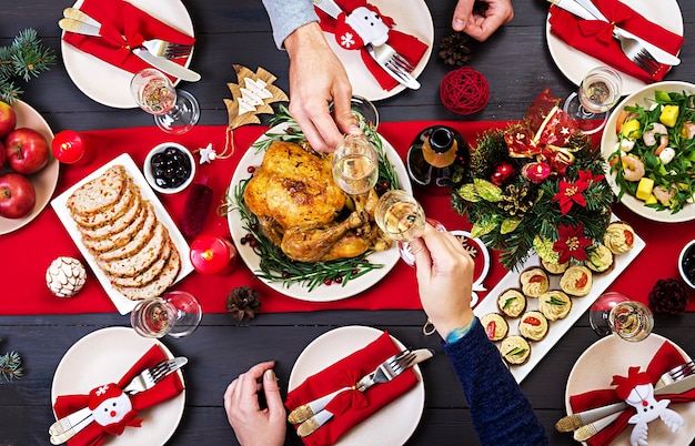 Baked turkey. The Christmas table is served with a turkey, decorated with bright tinsel 