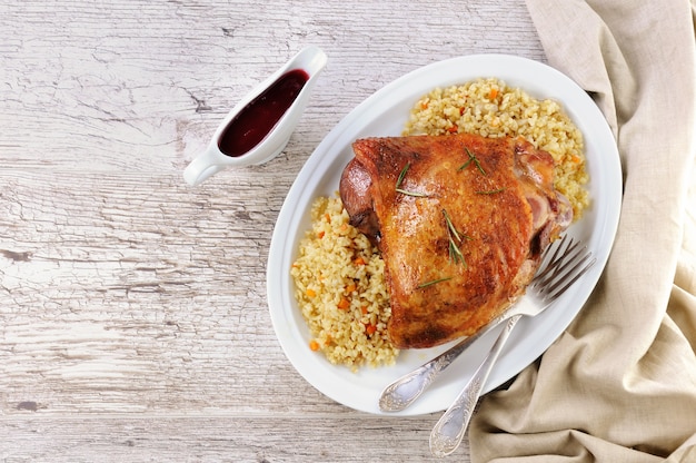 Baked turkey thigh with garnish bulgur and vegetables