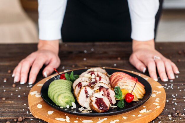 Baked veal decorated fresh fruits and sauce