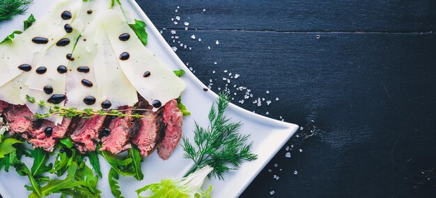 Baked Veal with Parmesan Cheese On a wooden background Top view Free space for your text