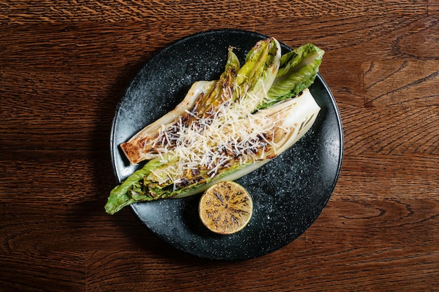 Baked vegetables salad on black plate