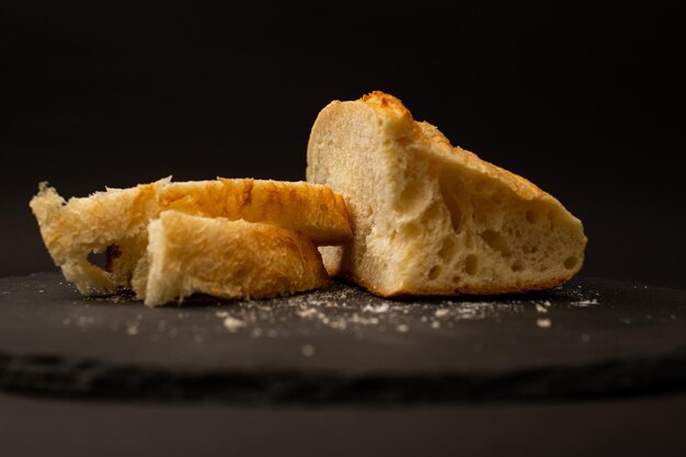 Baked white bread on a black background