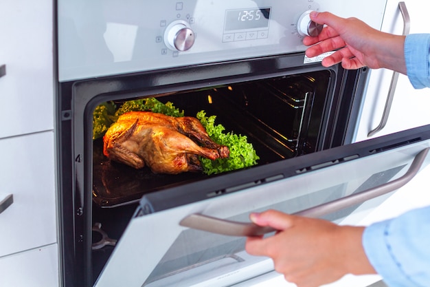 Baked whole chicken with vegetables in the oven for dinner at home