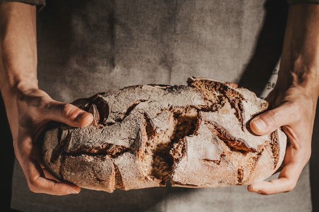 Baker or chef holding fresh made bread