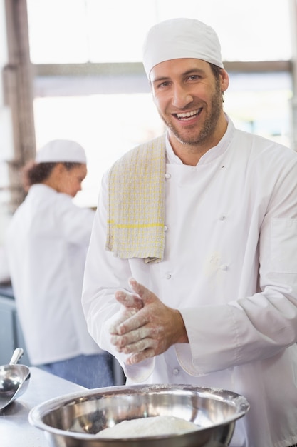 Baker clapping flour from his hands