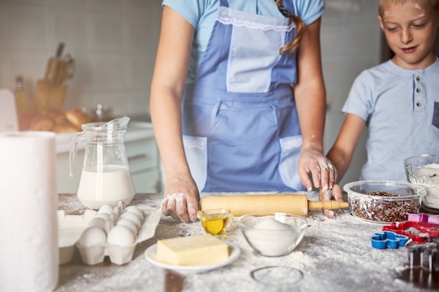 Baker and her little assistant rolling out dough