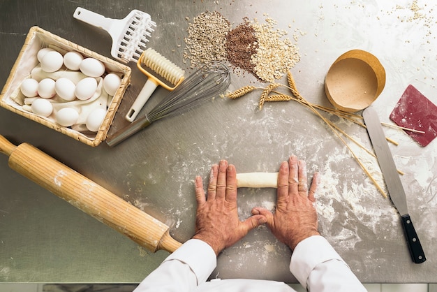 Baker kneading dough in a bakery