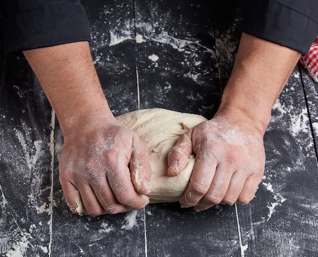 Baker kneads white wheat flour dough 