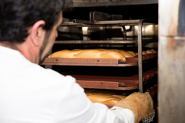 Baker making bread at a bakery