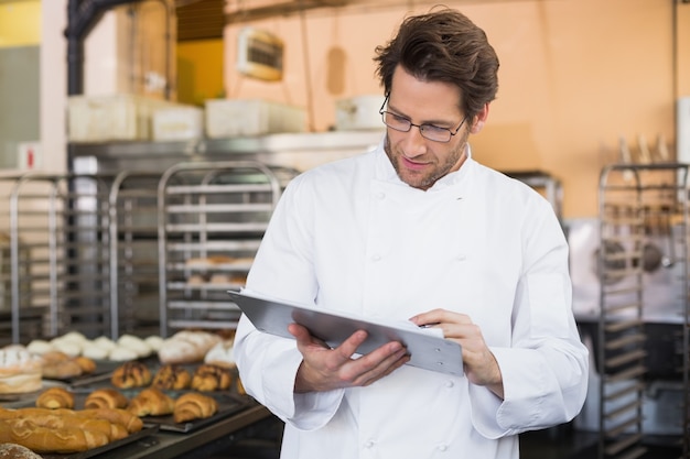 Baker reading something on clipboard