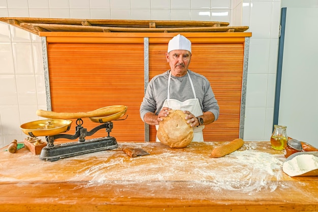 Baker showing a freshly baked bread