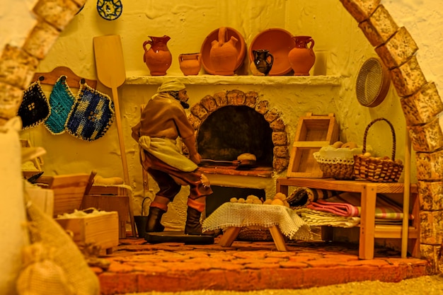 Photo baker taking bread out of the oven in a portal of bethlehem
