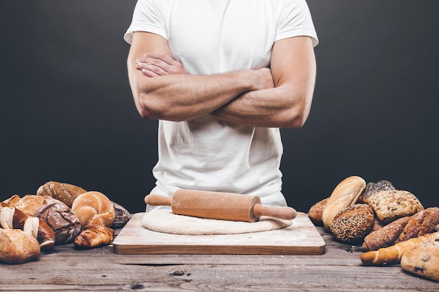 Baker with a variety of delicious freshly baked bread and pastry