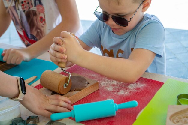 Bakers hand spraying eggwhite on gingerbreads