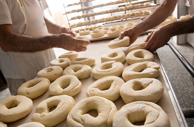 Bakers preparing dough for bagels