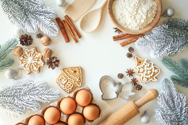 Bakery background with ingredients for cooking Christmas baking Flour eggs cinnamon and gingerbread on the table top view