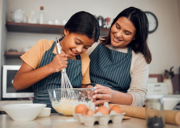 Bakery baking and woman with girl learning to bake cooking skill and development with happiness and help Mother child with fun activity and teaching to learn with food ingredients in family home