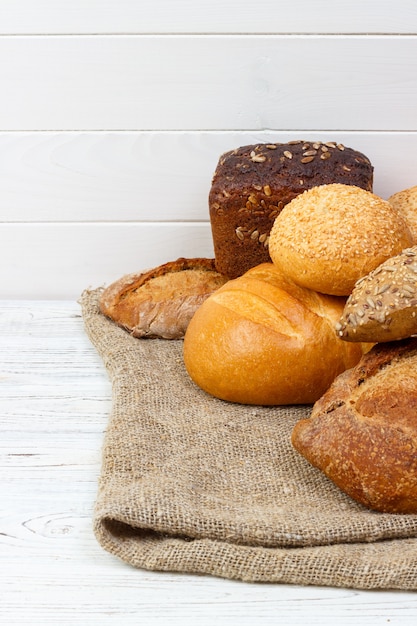 Bakery, bread assortment. Rye buns and french baguettes top view