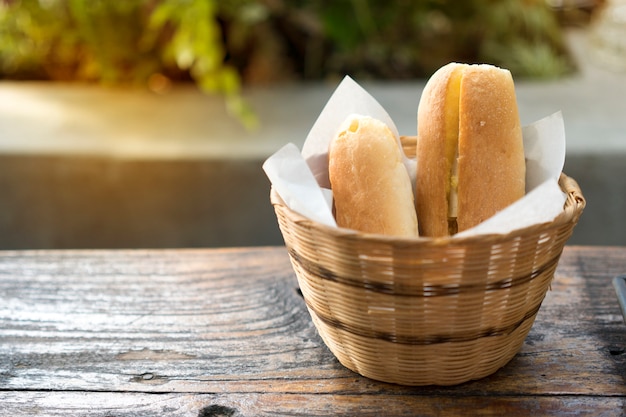 Bakery bread on wooden table on dark background.