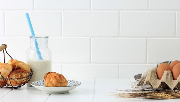 Bakery Concept WHite, Mini Croissant, Egg, and A Bottle of Milk. Copy Space for Advertisement/Text