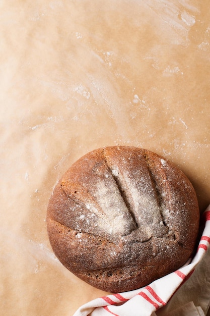 Bakery concept with bread and cloth on brown beige background flat lay