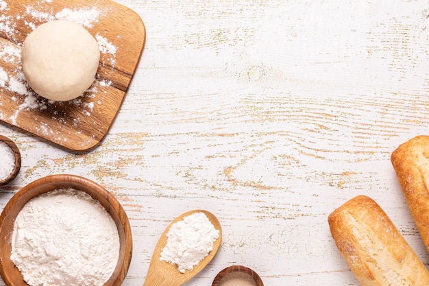 Bakery products -flour, dough, yeast, salt. Top view, copy space.