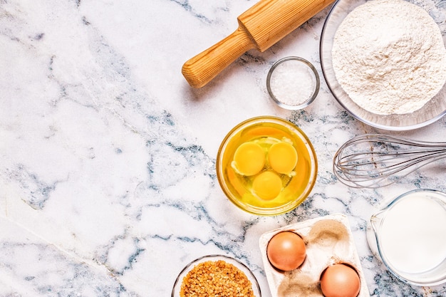 Bakery products -flour, eggs, milk. Top view, copy space.