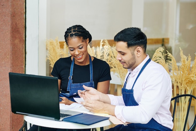 Bakery shop owners checking bills