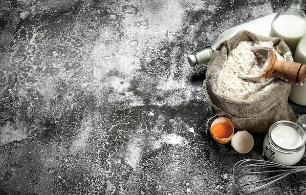 Baking background. Ingredients for the preparation of dough. On a rustic background.