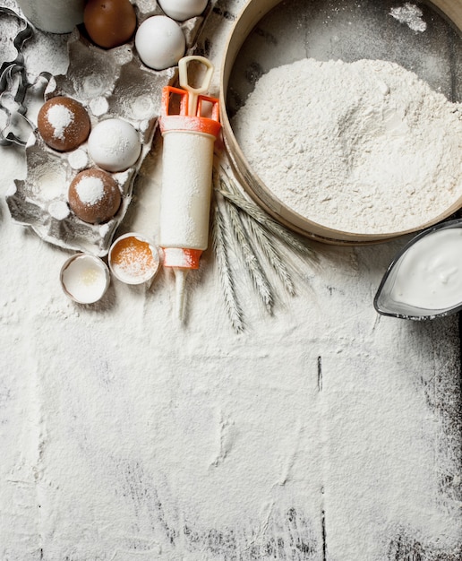 Baking background. Tools and ingredients for the dough.