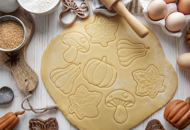 Baking cookies in the form of pumpkin and leaves