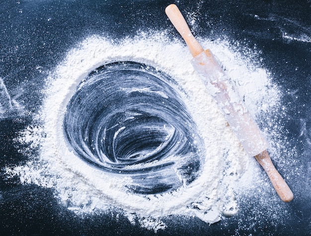 Baking desk with flour and rolling pin, top view