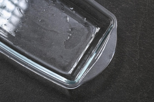 A baking dish cleaned from a thick layer of carbon glassware for baking after washing with a steam c...