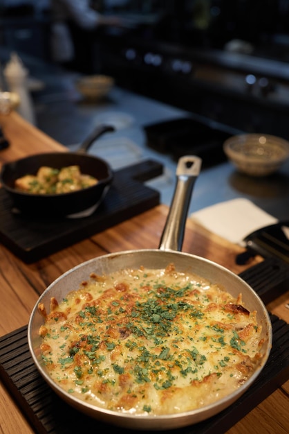 Baking dish with tasty potato casserole frying pan.