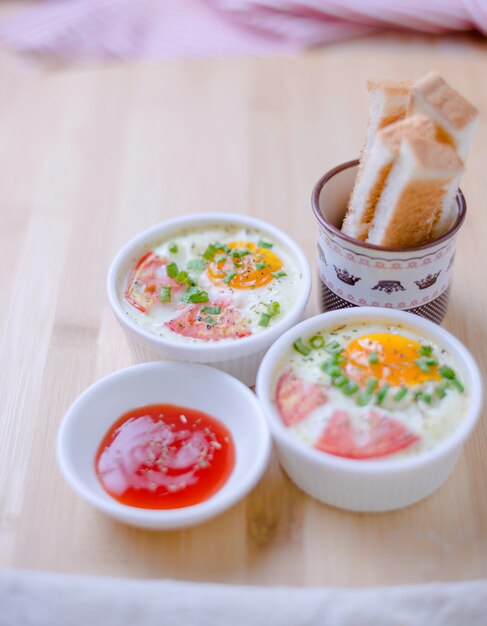 Baking egg and toasted bread on wooden table