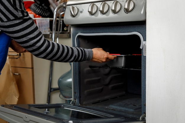 Baking at home Woman checking the cooking of a pancake in the stove oven