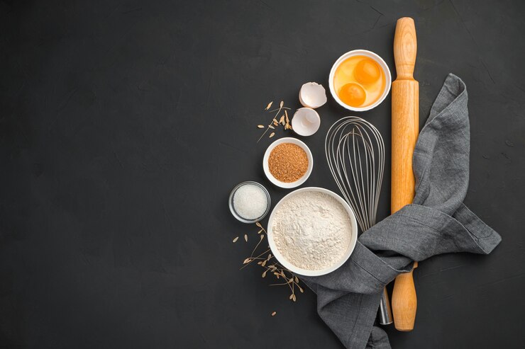 Photo baking ingredients on a black background flour eggs and sugar cooking dough dishes cooking background